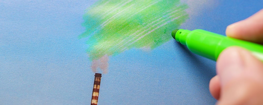 green marker coloring in, signifying greenwashing